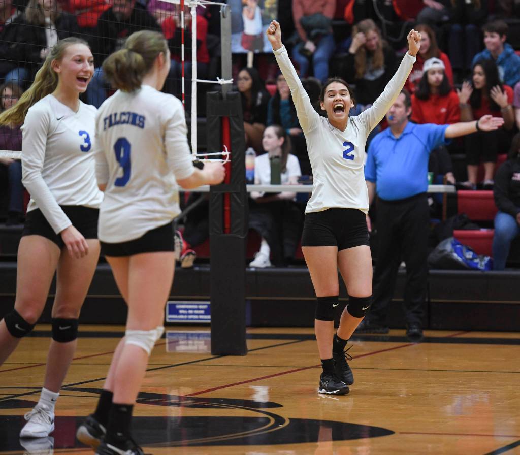 Thunder Mountains Amy Schoonover, right, celebrates a point in the final game against Juneau-Douglas with teammates Sophie Harvey, center, and Lilly Smith at Juneau-Douglas High School: Yadaa.at Kalé on Friday, Nov. 1, 2019. Thunder Mountain won 3-0 (25-14, 25-20, 25-20). ( Michael Penn | Juneau Empire)