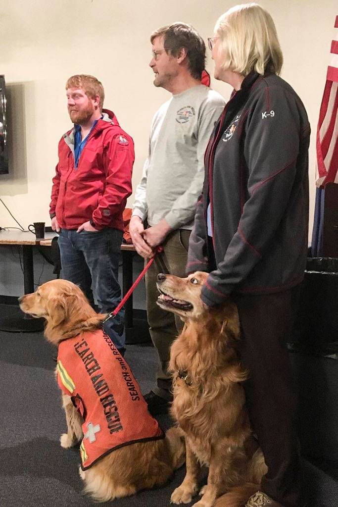 Search dogs with SEADOGS and their partners pose during a presentation at the Moose Lodge, Nov. 5, 2019. (Michael S. Lockett | Juneau Empire)
