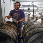 Matt Barnaby, co-owner and brewer at the Barnaby Brewing Company, works to fill wooden casks for a longer term beer project on Wednesday, Nov. 6, 2019. Barnaby has added his name to a list of commenters who dont like a proposed definition change by the Alcoholic Beverage Control Board that would limit the sorts of activities that can happen in breweries and distilleries. (Michael Penn | Juneau Empire)
