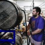 Matt Barnaby, co-owner and brewer at the Barnaby Brewing Company, works to fill wooden casks for a longer term beer project on Wednesday, Nov. 6, 2019. Barnaby has added his name to a list of commenters who dont like a proposed definition change by the Alcoholic Beverage Control Board that would limit the sorts of activities that can happen in breweries and distilleries. (Michael Penn | Juneau Empire)