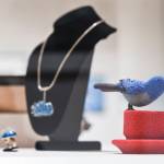 Work by Terri Atwell, titled Early Bird, right, made from glass beads and resin on display along with Kristy Summers necklace and rings, titled Sea Urchin, made of silver and enamel at the All-Alaska Biennial exhibit at the Alaska State Museum on Wednesday, Nov. 6, 2019. The exhibit runs until Jan. 11. Winter hours for the museum are 10 a.m.-4 p.m Tuesday-Saturday. (Michael Penn | Juneau Empire)