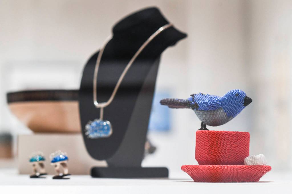 Work by Terri Atwell, titled Early Bird, right, made from glass beads and resin on display along with Kristy Summers necklace and rings, titled Sea Urchin, made of silver and enamel at the All-Alaska Biennial exhibit at the Alaska State Museum on Wednesday, Nov. 6, 2019. The exhibit runs until Jan. 11. Winter hours for the museum are 10 a.m.-4 p.m Tuesday-Saturday. (Michael Penn | Juneau Empire)