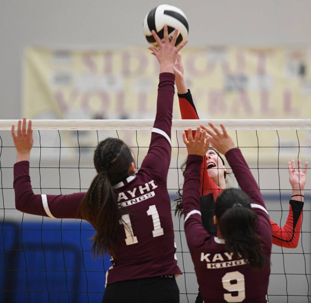 Juneau-Douglas Jenae Pusich tips the ball against Ketchikans Lindsey Byron, left, and Maddy Purcell during the Region V Volleyball Tournament at Thunder Mountain High School on Thursday, Nov. 7, 2019. JDHS won 25-8, 25-14, 14-25, 25-15. (Michael Penn | Juneau Empire)
