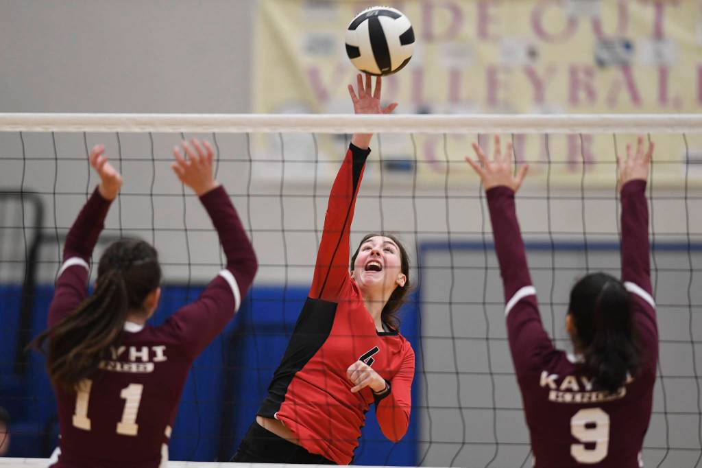 Juneau-Douglas Jenae Pusich spikes the ball against Ketchikans Lindsey Byron, left, and Maddy Purcell during the Region V Volleyball Tournament at Thunder Mountain High School on Thursday, Nov. 7, 2019. JDHS won 25-8, 25-14, 14-25, 25-15. (Michael Penn | Juneau Empire)