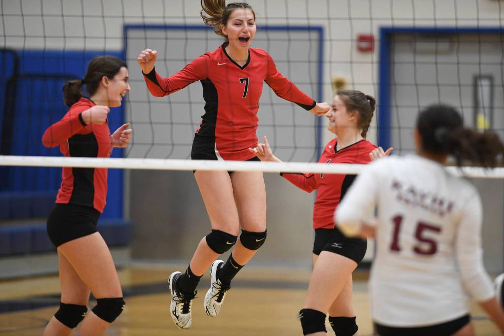 Juneau-Douglas Addie Prussing, left, Jojo Griggs, center, and Kiana Potter celebrate a point against Ketchikan during the Region V Volleyball Tournament at Thunder Mountain High School on Thursday, Nov. 7, 2019. JDHS won 25-8, 25-14, 14-25, 25-15. (Michael Penn | Juneau Empire)