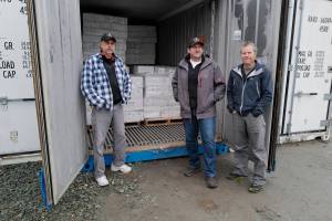 Chris Shapp, left, and Dave Lefebvre, center, of the Southeast Alaska Food Bank, stand with Jim Harmon, executive director of SeaShare, on Thursday, Nov. 7, 2019. Seashare donated a 40-foot freezer van and 20,000 pounds of seafood to the foodbank. SeaShare is a nonprofit founded in 1994 to help the seafood industry donate to hunger-relief efforts. The effort has prevented 5 million pounds of bycatch over 25 years from being dumped back into the ocean. (Michael Penn | Juneau Empire)