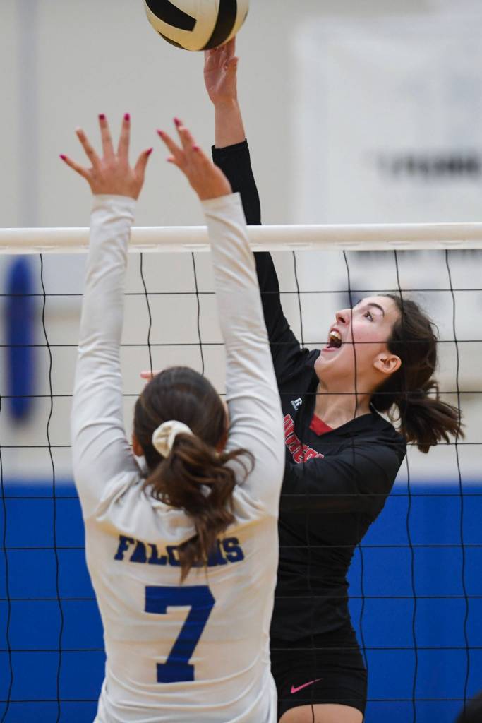 Juneau-Douglas Jenae Pusich spikes the ball against Thunder Mountains Avery Kreischer during the Region V Volleyball Tournament at Thunder Mountain High School on Friday, Nov. 8, 2019. JDHS won 25-22, 26-24, 25-20. (Michael Penn | Juneau Empire)