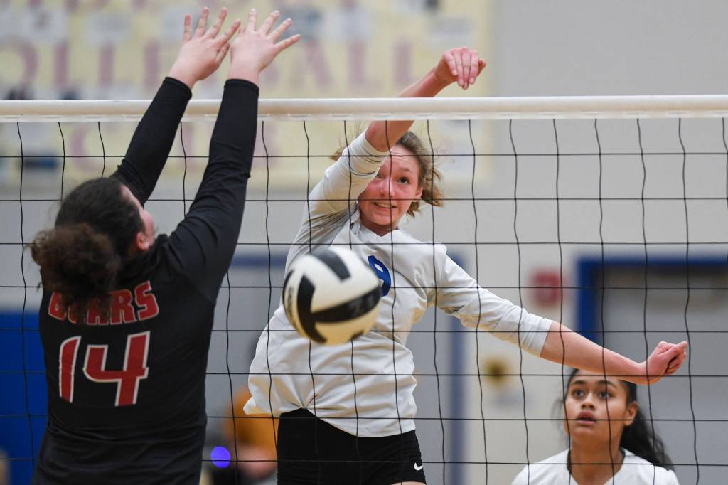 Thunder Mountains Sophie Harvey spikes the ball against Juneau-Douglas Gabi Griggs during the Region V Volleyball Tournament at Thunder Mountain High School on Friday, Nov. 8, 2019. JDHS won 25-22, 26-24, 25-20. (Michael Penn | Juneau Empire)