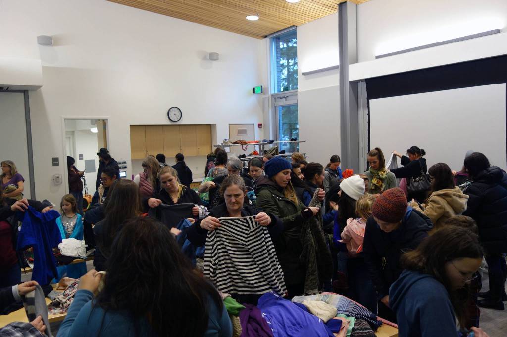 A community clothing swap attracted more than 100 people to the Mendenhall Valley Public Library Saturday, Nov. 9. (Ben Hohenstatt | Juneau Empire)
