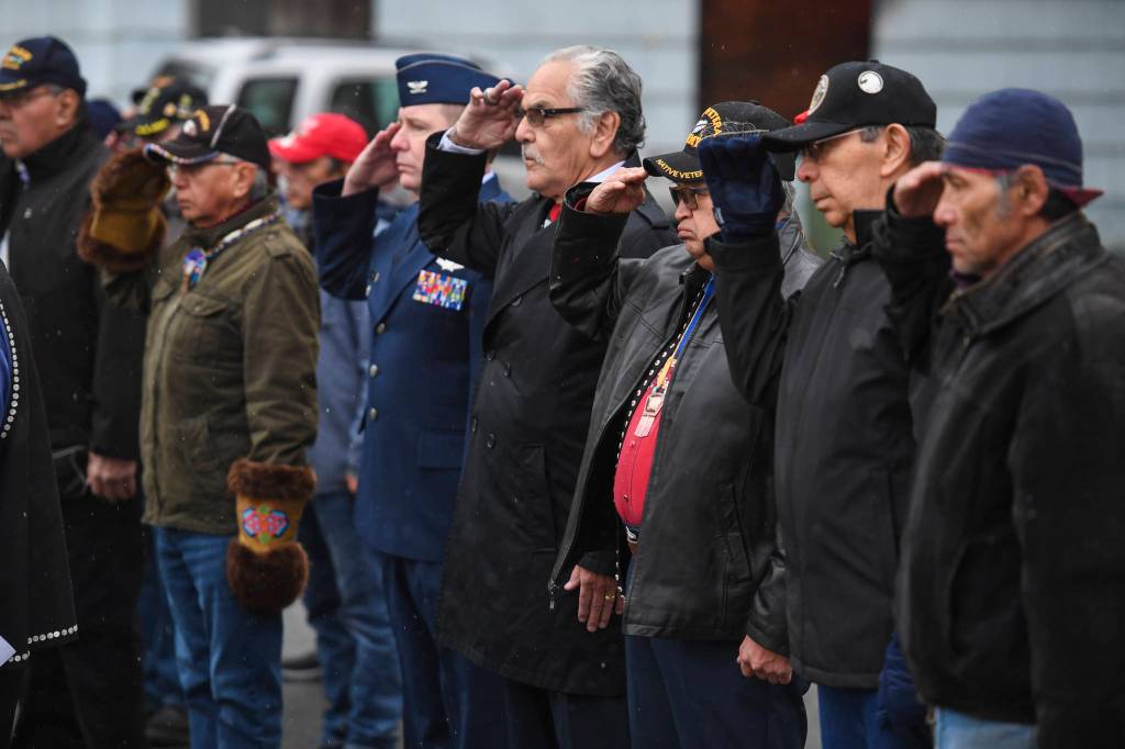 Veterans salute during the Veterans Day Ceremony at the SE Alaska Native Veterans Park on Monday, Nov. 11, 2019. (Michael Penn | Juneau Empire)