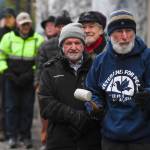 Paul DeSloover, right, and other members of Juneau Chapter of Veterans for Peace line up to ring Alaskas copy of the Liberty Bell in front of the Capitol on Monday, Nov. 11, 2019. (Michael Penn | Juneau Empire)