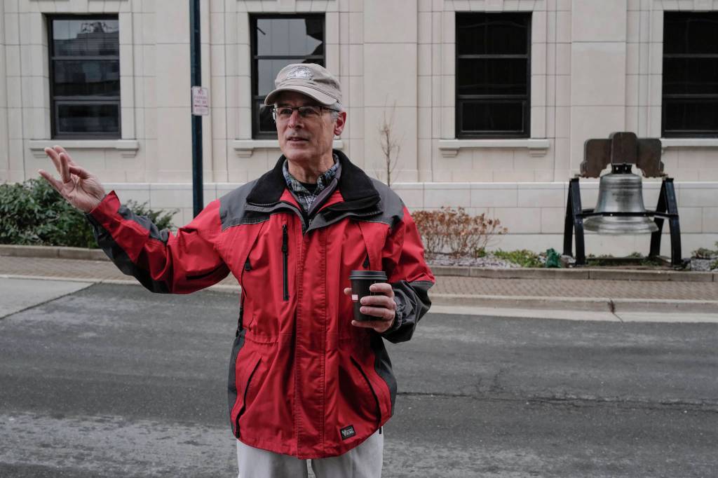 Veterans for Peace President Craig Wilson talks about what it means to ring Alaskas copy of the Liberty Bell in front of the Capitol on Monday, Nov. 11, 2019. The practice of ringing a bell came from Armistice Day, the ending of WW1 on Nov. 1, 1918. (Michael Penn | Juneau Empire)