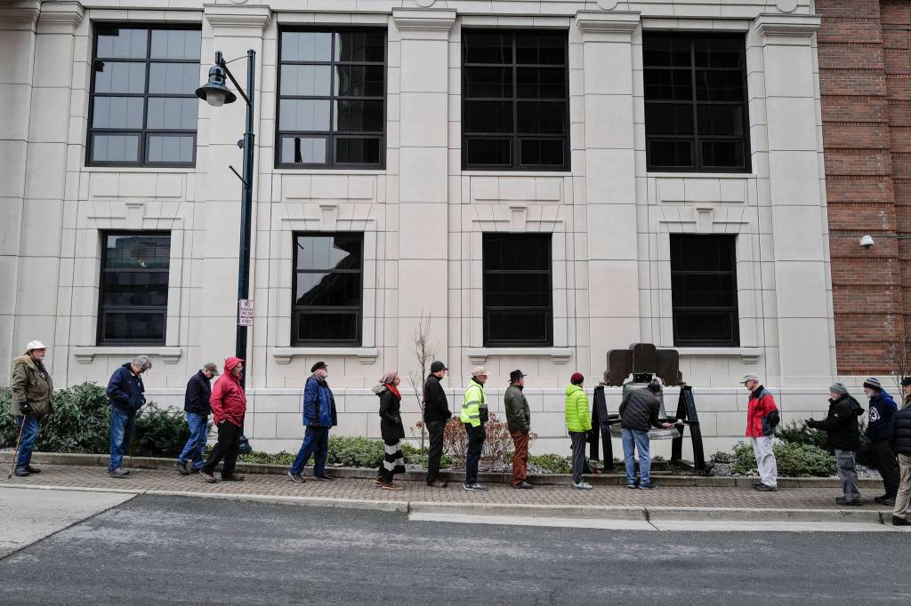 Members of the Juneau Chapter of Veterans for Peace and others line up to ring Alaskas copy of the Liberty Bell in front of the Capitol for Veterans Day on Monday, Nov. 11, 2019. (Michael Penn | Juneau Empire)