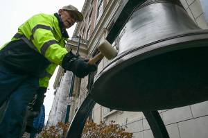 Gene Miller of the Juneau Chapter of Veterans for Peace rings Alaskas copy of the Liberty Bell in front of the Capitol for Veterans Day on Monday. Learn more by watching the video below. (Michael Penn | Juneau Empire)