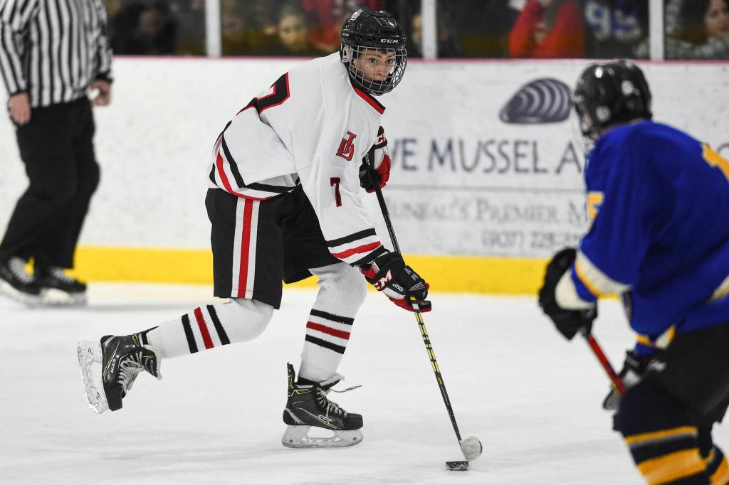 Juneau-Douglas Fin Shibler brings the puck against Monroe Catholic at the Treadwell Arena on Friday, Nov. 15, 2019. JDHS won 13-0. (Michael Penn | Juneau Empire)