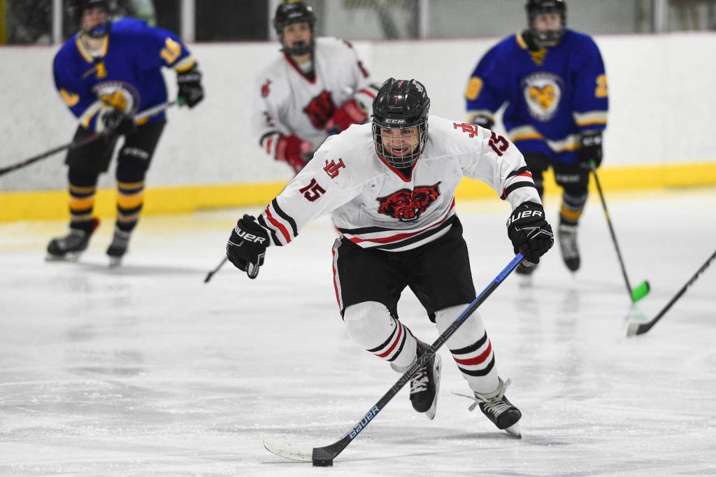 Juneau-Douglas Josh Frisby moves the puck against Monroe Catholic at the Treadwell Arena on Friday, Nov. 15, 2019. JDHS won 13-0. (Michael Penn | Juneau Empire)