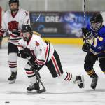 Juneau-Douglas Taylor Bentley moves the puck against Monroe Catholics Dom Coiley at the Treadwell Arena on Friday, Nov. 15, 2019. JDHS won 13-0. (Michael Penn | Juneau Empire)