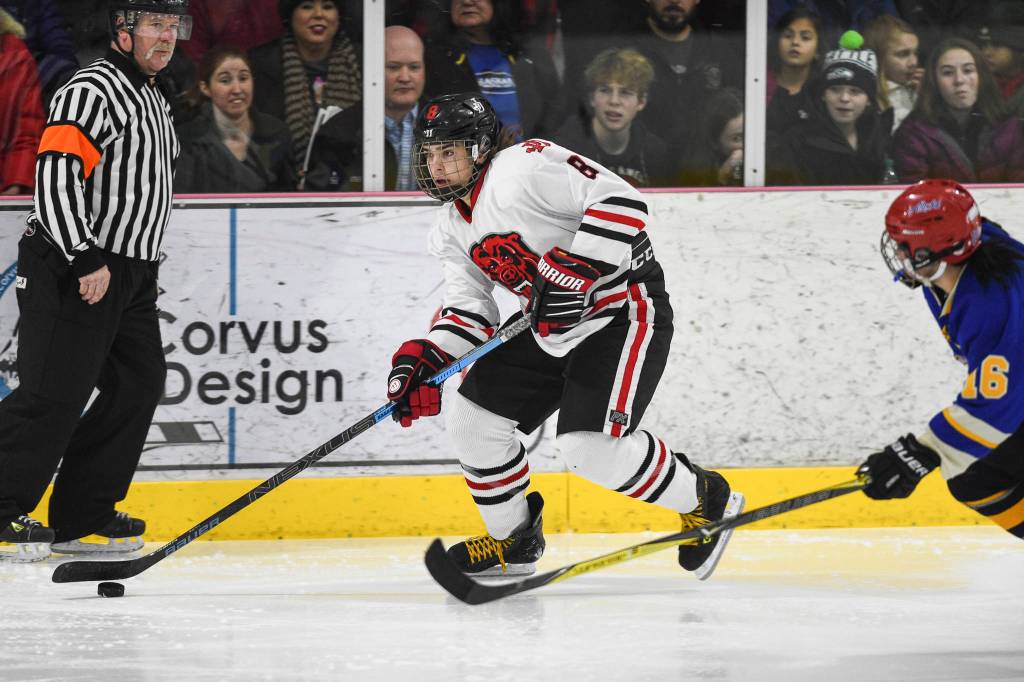 Juneau-Douglas Dylan Murdoch moves the puck against Monroe Catholics Sophie Fowler at the Treadwell Arena on Friday, Nov. 15, 2019. JDHS won 13-0. (Michael Penn | Juneau Empire)