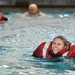 Operational Specialist 1st Class Marylee Florscher, a Coast Guardsman stationed in Juneau, takes a boating safety training class at the Augustus Brown Swimming Pool on Tuesday, Nov. 19, 2019. The class will qualify the members to teach students around the state about the use and importance of life vests. (Michael Penn | Juneau Empire)