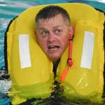 Lt. Cmdr. Kevin Dugan, a Coast Guards officer stationed in Juneau, takes a boating safety training class at the Augustus Brown Swimming Pool on Tuesday, Nov. 19, 2019. The class will qualify the members to teach students around the state about the use and importance of life vests. (Michael Penn | Juneau Empire)