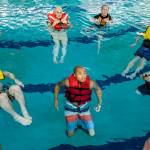 Members of the U.S. Coast Guard stationed in Juneau take a boating safety training class at the Augustus Brown Swimming Pool on Tuesday, Nov. 19, 2019. The class will qualify the members to teach students around the state about the use and importance of life vests. (Michael Penn | Juneau Empire)