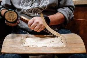 Tsimshian Artist David R. Boxley works on a feast tray made out of alder at the Walter Soboleff Building on Tuesday, Nov. 19, 2019. Boxley is spending the week demostrating his craft for the Sealaska Heritage Institute. (Michael Penn | Juneau Empire)