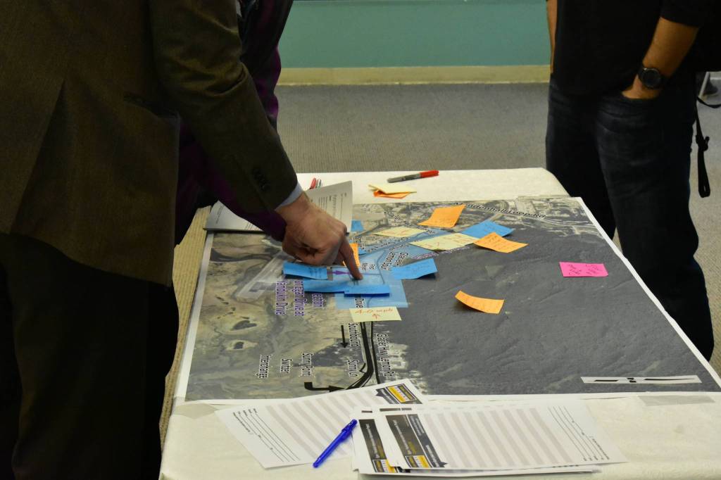 People add comments to a map of the project area at a Department of Transportation and Public Facilities community meeting at the Nugget Mall on Tuesday, Nov. 19, 2019. (Peter Segall | Juneau Empire)
