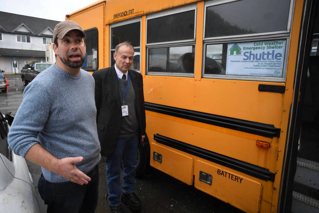 Cold Weather Emergency Shelter Manager Richard Cole, left, and St. Vincent de Paul Society Juneau General Manager Bradley Perkins show their used school bus on Wednesday, Nov. 20, 2019, that will be used to transport people needing a warm place to sleep to the shelter at St. Vincent de Paul. (Michael Penn | Juneau Empire)