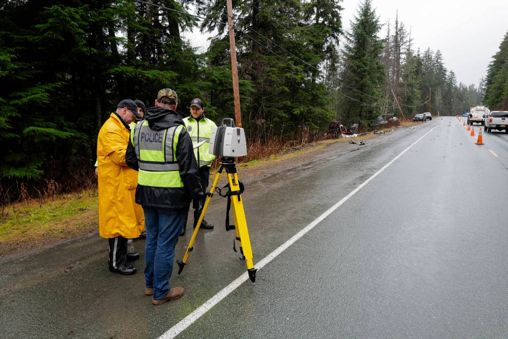 Juneau Police Department officers document a single-vehicle wreck near Mile 20 Glacier Highway that left 2 dead and 2 in critical condition on Thursday, Nov. 21, 2019. (Michael Penn | Juneau Empire)