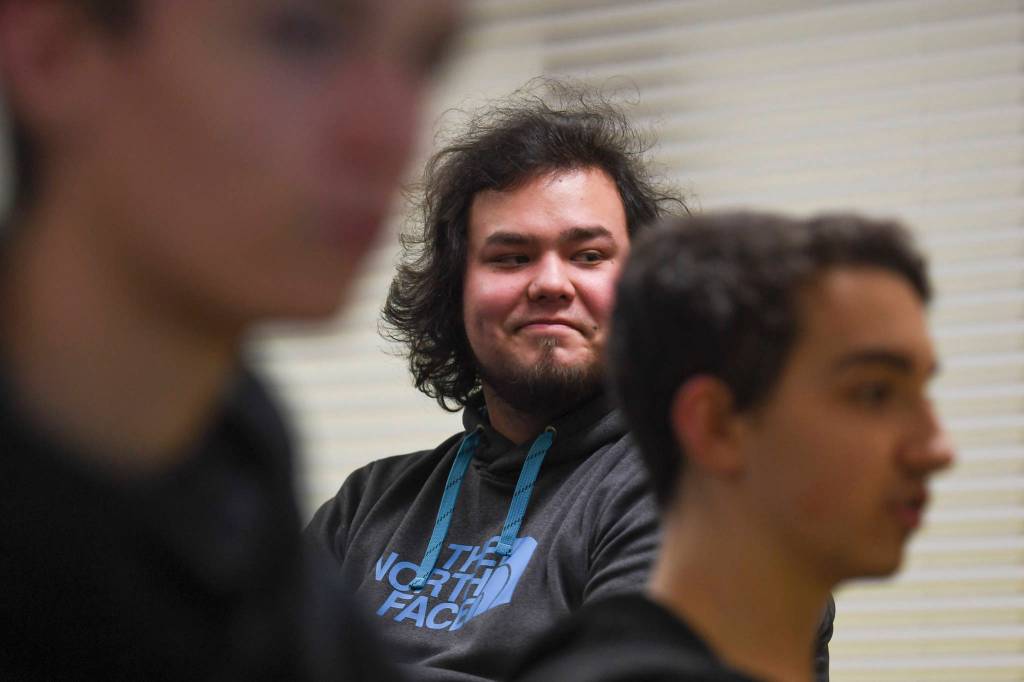 Mason Shearer, Thunder Mountain High School esports coach, watches junior Norman Abel, left, and senior Hunter Greene practice Rocket League at TMHS on Thursday, Nov. 21, 2019. (Michael Penn | Juneau Empire)