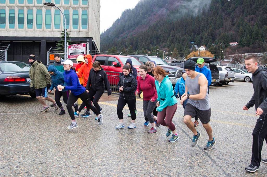 Coast Guardsmen and civilian employees take off at the start of a 5K Turkey Trot down through Juneaus harborfront on Nov. 22, 2019. (Michael S. Lockett | Juneau Empire)
