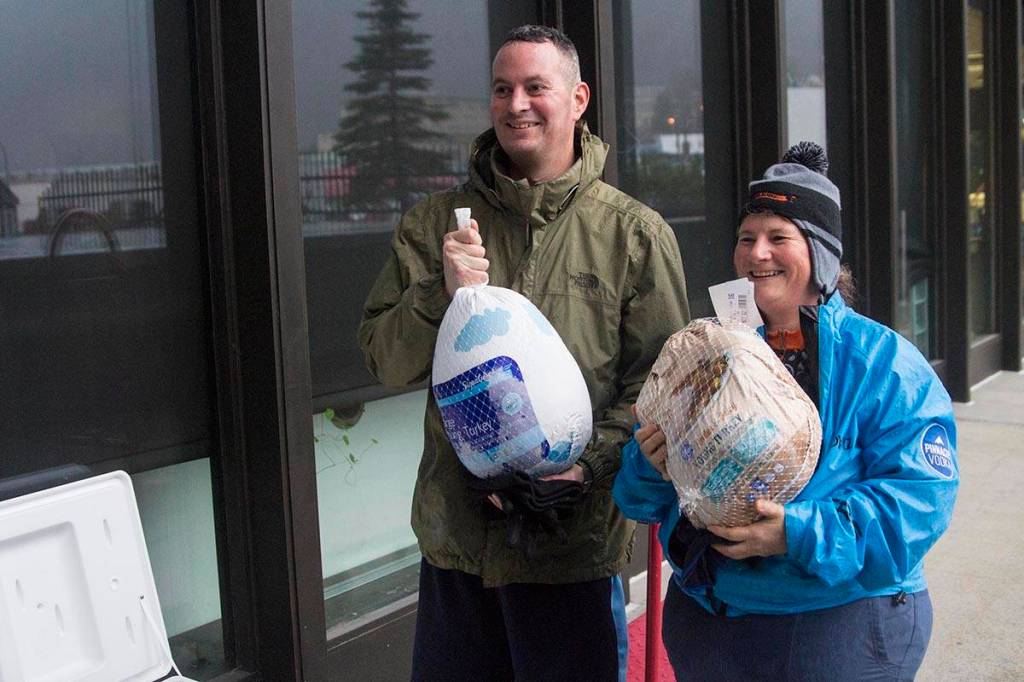 Chief Petty Officer Matthew Schofield and Jenny Smith, a civilian engineer with the Civil Engineering Unit, won turkeys in a raffle following the Coast Guards 5K Turkey Trot through Juneaus harborfront on Nov. 22, 2019. (Michael S. Lockett | Juneau Empire)