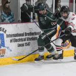 Juneau-Douglas Josh Frisby, right, competes against Colonys Blake Reid for the puck at Treadwell Arena on Friday, Nov. 22, 2019. (Michael Penn | Juneau Empire)