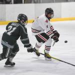 Juneau-Douglas Andre Peirovi, right, flicks the puck away from Colonys Jacob Ross at Treadwell Arena on Friday, Nov. 22, 2019. (Michael Penn | Juneau Empire)