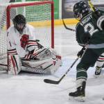 Colonys Jacob Ross, right, gets the puck over Juneau-Douglas goalkeeper Cody Mitchells glove to score in the second period at Treadwell Arena on Friday, Nov. 22, 2019. (Michael Penn | Juneau Empire)
