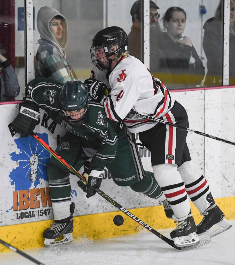 Juneau-Douglas Ethan Welch, right, pressures a Colony player at Treadwell Arena on Friday, Nov. 22, 2019. (Michael Penn | Juneau Empire)