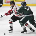 Juneau-Douglas Zac Stagg, left, moves the puck against Colonys Cauy Trangmoe at Treadwell Arena on Friday, Nov. 22, 2019. (Michael Penn | Juneau Empire)