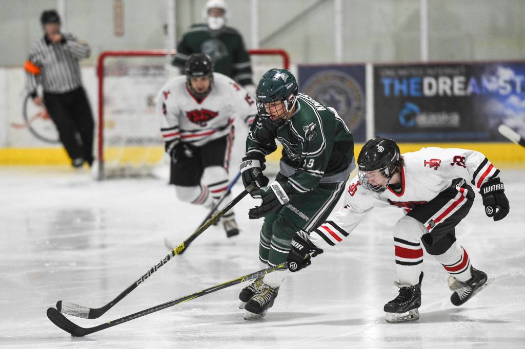 Juneau-Douglas Evan Fabrello, right, attempts a steal against Colonys Carsen Lantto at Treadwell Arena on Friday, Nov. 22, 2019. (Michael Penn | Juneau Empire)