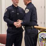 Sean Imhof shakes Chief Ed Mercers hand after being sworn into the Juneau Police Department as an officer on Wednesday, Nov. 27, 2019. (Michael S. Lockett | Juneau Empire)