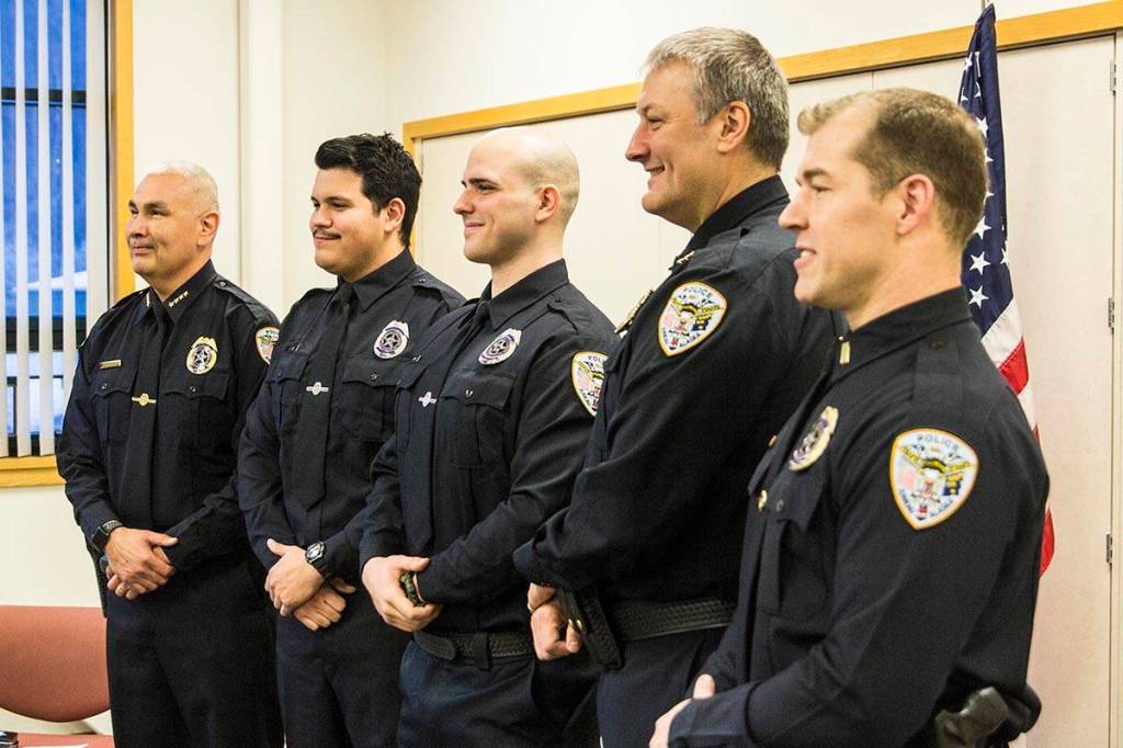 Officers of the Juneau Police Department pose for a photo with new officers after they were sworn in on Wednesday, Nov. 27, 2019. (Michael S. Lockett | Juneau Empire)