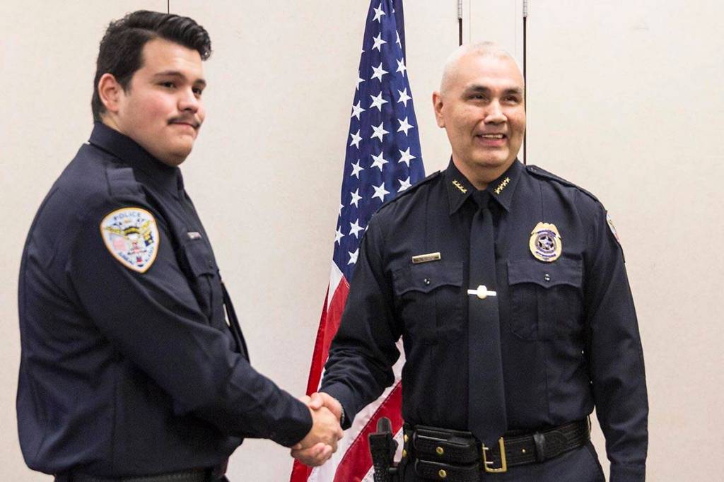 Tyler Reid shakes Chief Ed Mercers hand after being sworn into the Juneau Police Department as an officer on Wednesday, Nov. 27, 2019. (Michael S. Lockett | Juneau Empire)