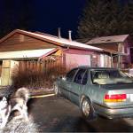 Roy Cerros stands outside his home on Birch Lane. He pointed to the back half of the roof, saying he knew thats where the fire was because its clear of snow. (Peter Segall | Juneau Empire)