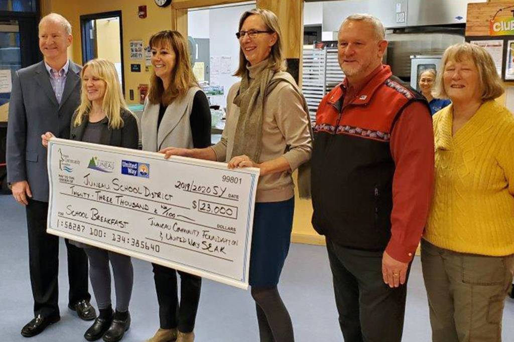 From left, Brian Holst of the Juneau Economic Development Council and School Board president; Adrianne Schwartz, Food Services Supervisor and Energy Manager for Juneau School District; Dr. Bridget Weiss, Juneau School District Superintendent; Amy Skilbred, Executive Director of Juneau Community Foundation; Warren Russell, United Way of Southeast Alaska Chair Board of Directors; and Millie Ryan, Secretary to the Board of United Way, pose for a picture after the Universal Breakfast Check presentation. (Courtesy photo)