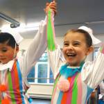 Caleb Aube and Tori Jacobson raise their arms and smile Saturday, Dec. 1, during rehearsals for Juneau Dance Theatres production of The Nutcracker. (Ben Hohenstatt | Capital City Weekly)