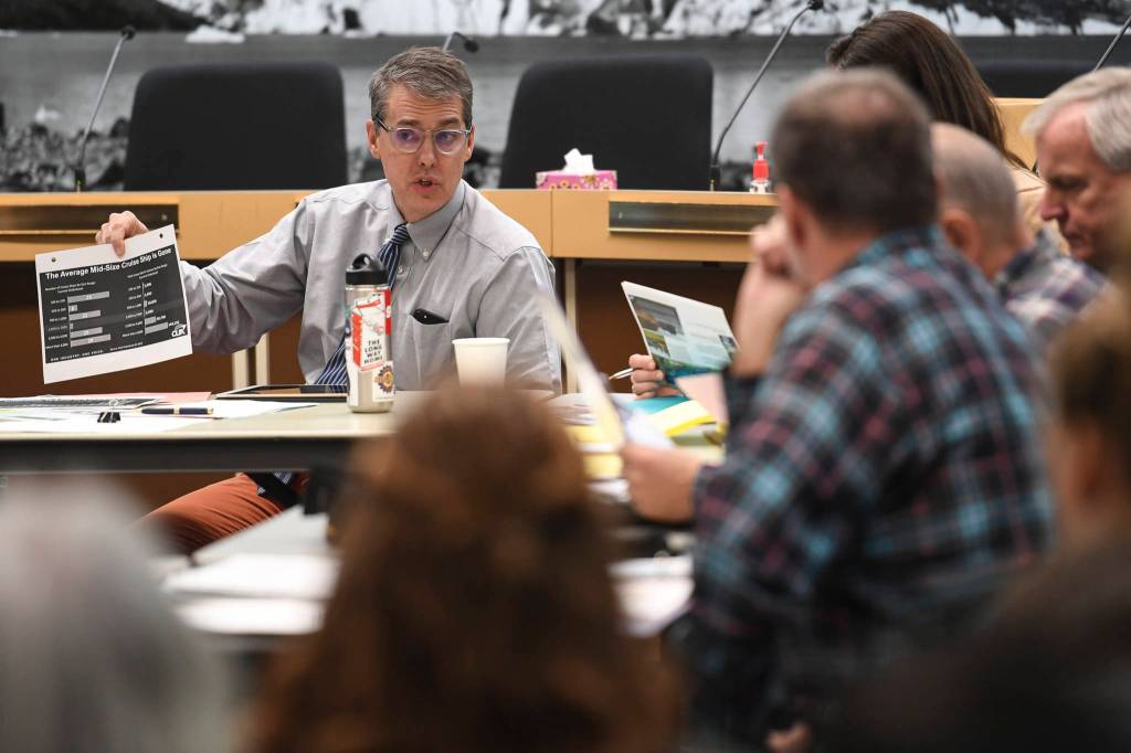 Juneau City Manager Rorie Watt holds up a chart showing the increase in size of cruise ships during a meeting of the Tourism Industry Task Force in the Assembly chambers on Tuesday, Dec. 3, 2019. (Michael Penn | Juneau Empire)