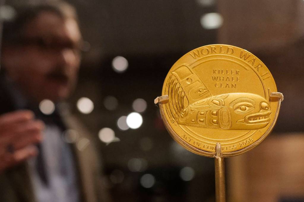 Chuck Smythe, Ph.D., History and Culture Director for Sealaska Heritage Institute, gives a tour on Friday, Dec. 6, 2019, of a new exhibit, War & Peace that includes a Congressional Gold Medal presented to the Daklaweidi (Killer Whale Clan) of Angoon in recognition of Tlingit speakers who served in World War II. (Michael Penn | Juneau Empire)
