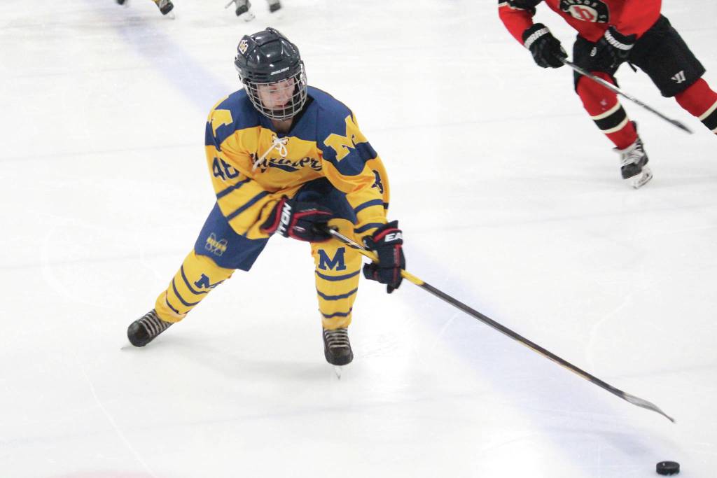 Homers Fiona Hatton reaches for the puck during a Friday, Dec. 6, 2019 hockey game against Juneau-Douglas High School at the Kevin Bell Arena in Homer, Alaska. (Photo by Megan Pacer/Homer News)