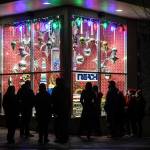 Juneau residents take in the decorated window display at REACH during Gallery Walk on Friday, Dec. 6, 2019. (Michael Penn | Juneau Empire)