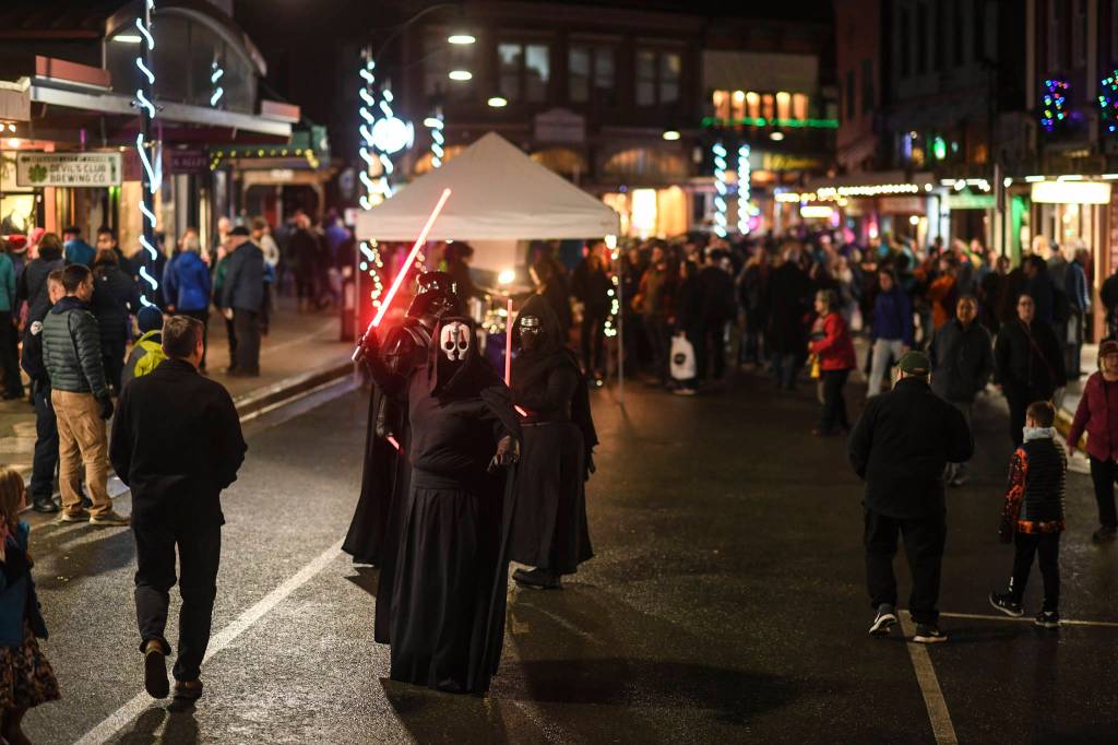 Residents walk Front Street during Gallery Walk on Friday, Dec. 6, 2019. (Michael Penn | Juneau Empire)