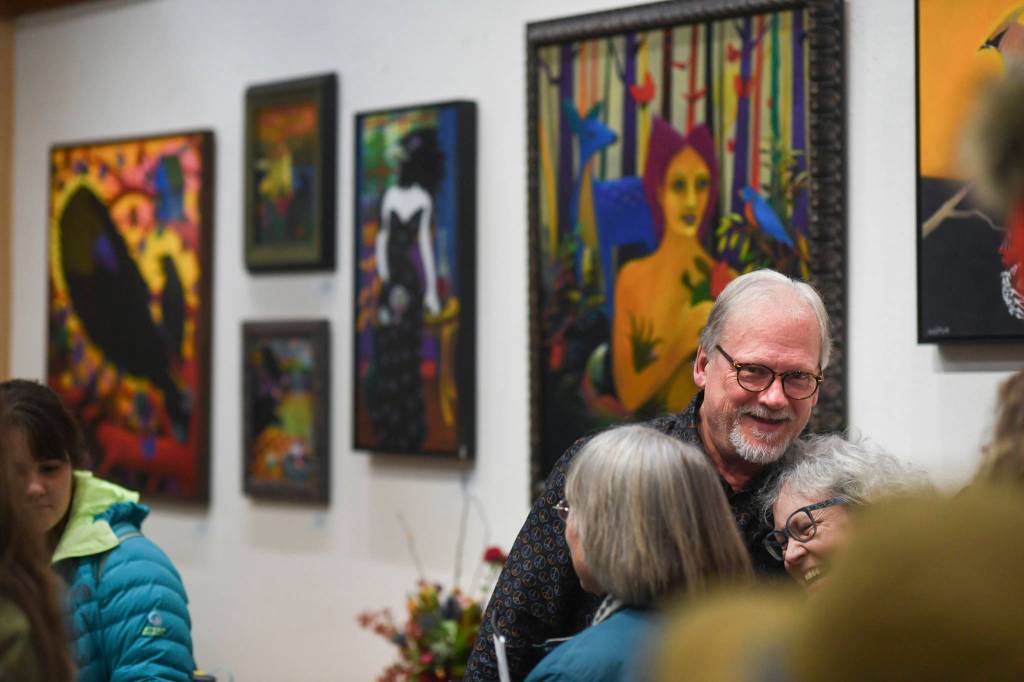 Rick Clair is greeted by friends while showing his latest work at Annie Kaills during Gallery Walk on Friday, Dec. 6, 2019. (Michael Penn | Juneau Empire)